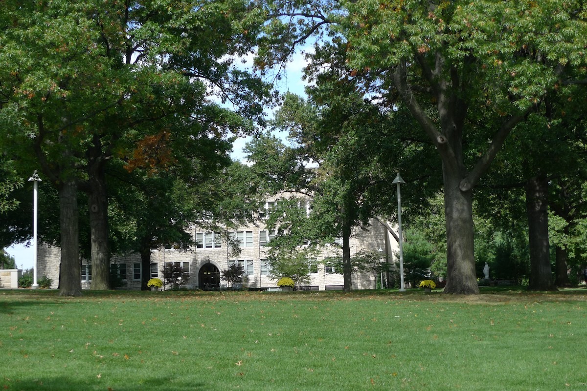 The Quad (grassy area surrounded by trees) with Conway Hall in the background