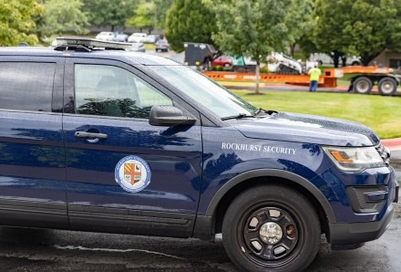A Rockhurst University security car sits in front of campus.