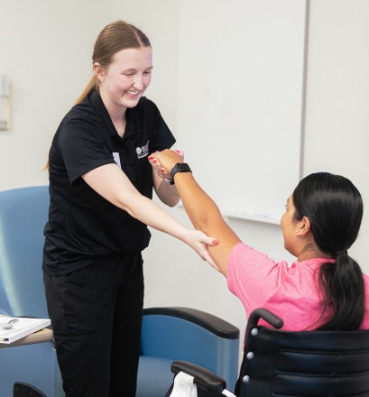 Two occupational therapy doctorate students practice techniques