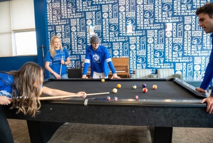 Students playing pool in the rock room