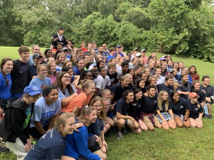Large group of students with arms around each other